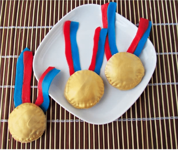 White plate with edible gold medals on top