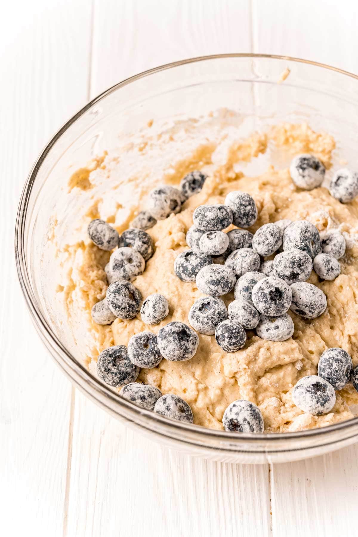 glass bowl with batter for blueberry muffins