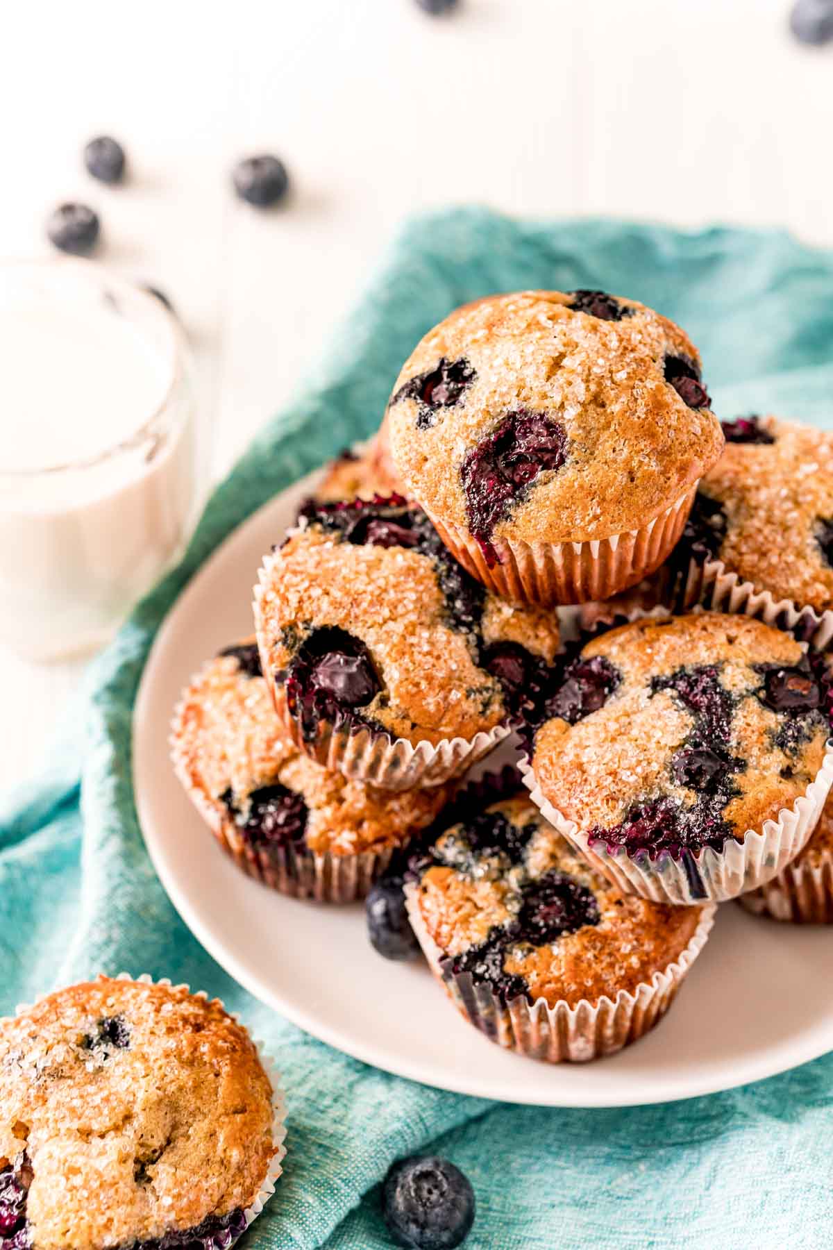 white plate with stack of blueberry muffins