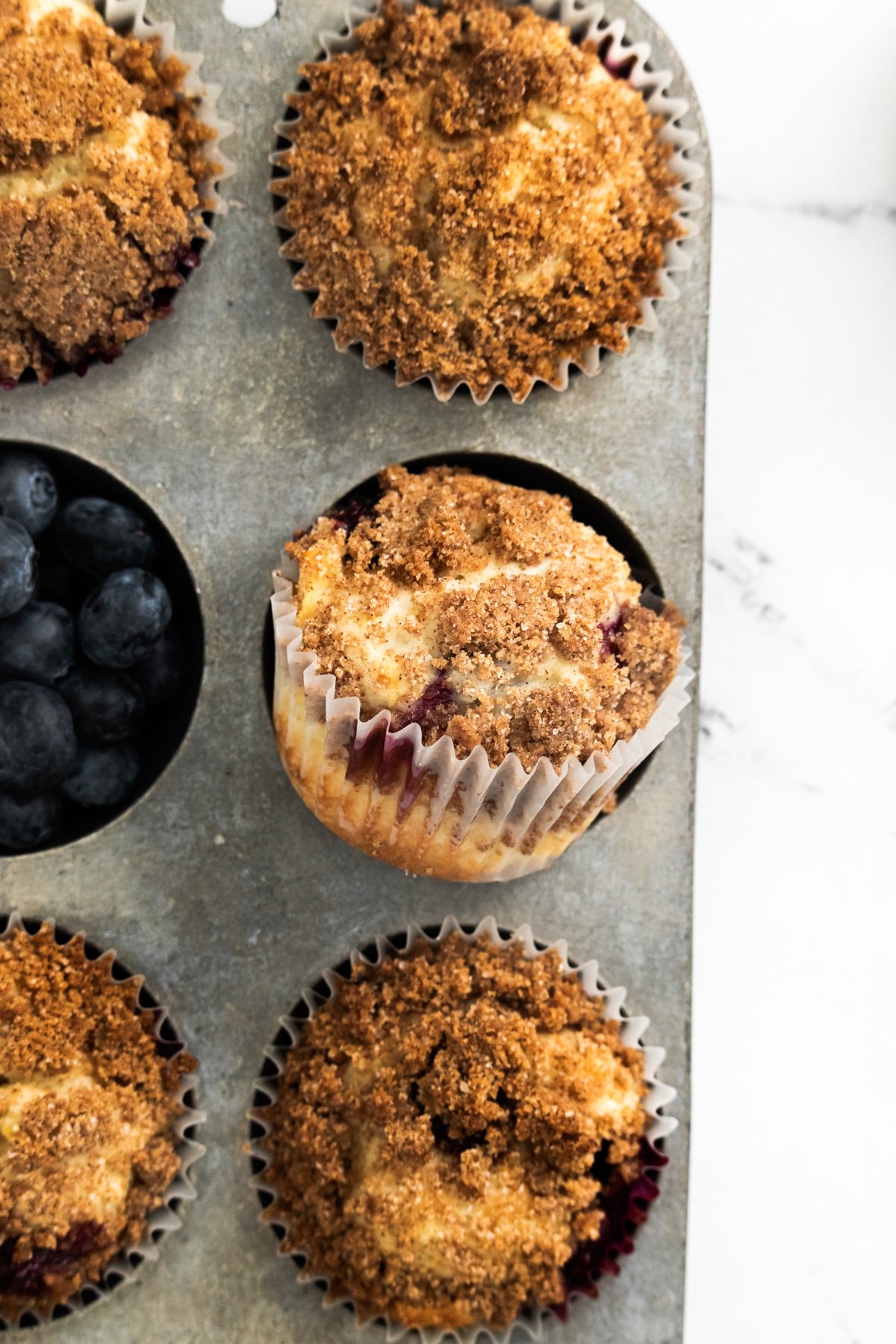 muffin tin with lemon blueberry muffins