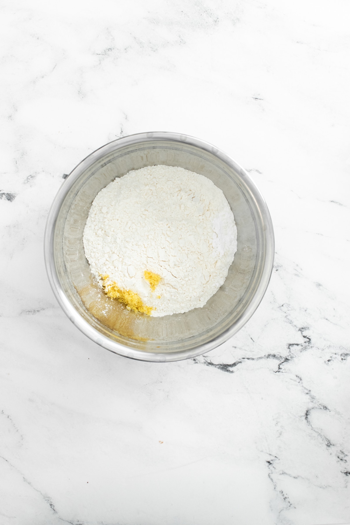 metal bowl with flour and lemon zest