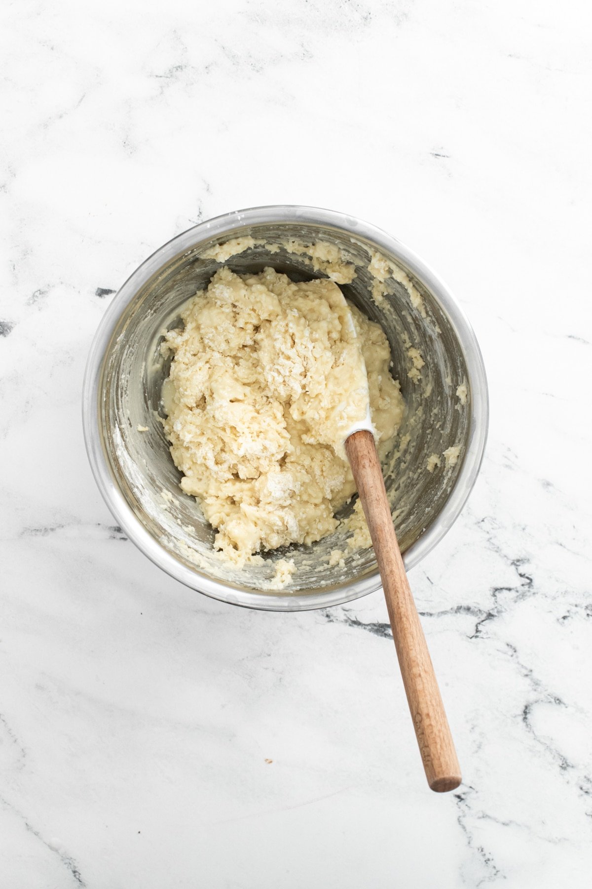 batter for lemon blueberry muffins in a metal bowl