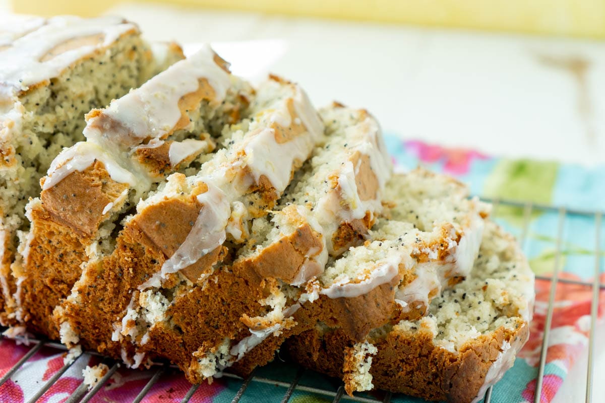 sliced loaf of lemon poppy seed bread with glaze