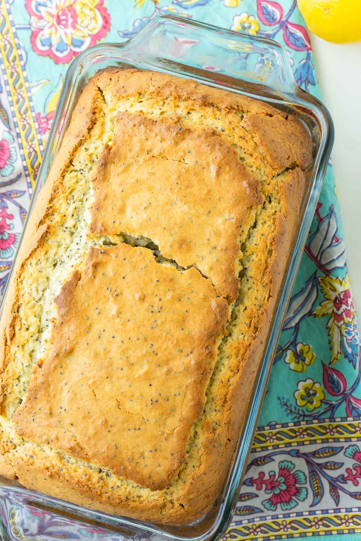 Baked lemon poppy seed bread on a floral napkin