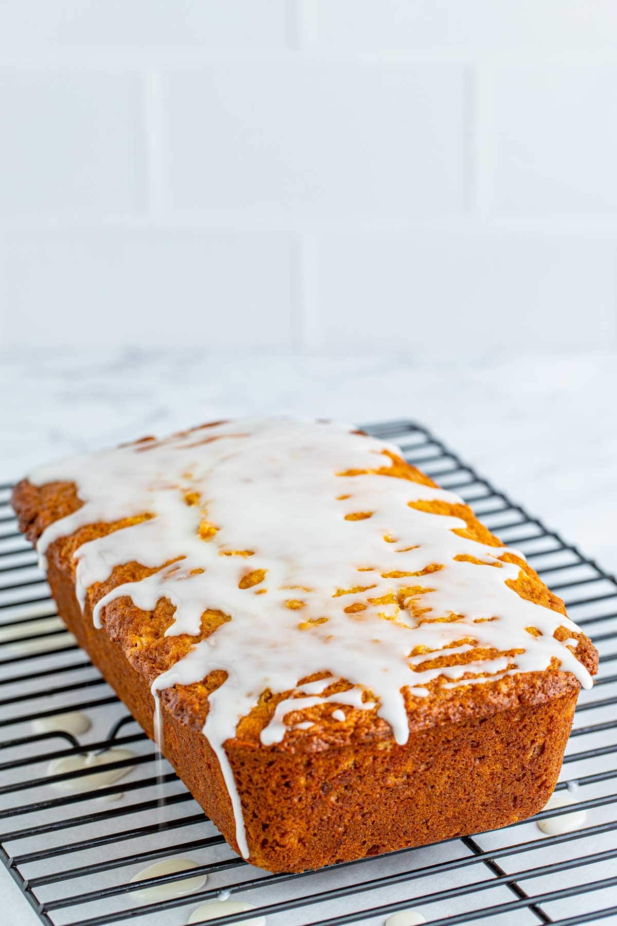 pineapple bread with glaze on top of a wire rack