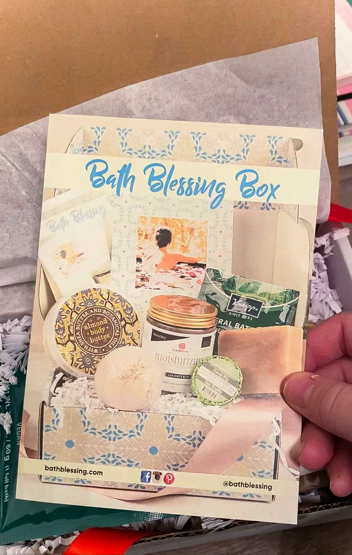 Hand holding a Bath Blessing box brochure