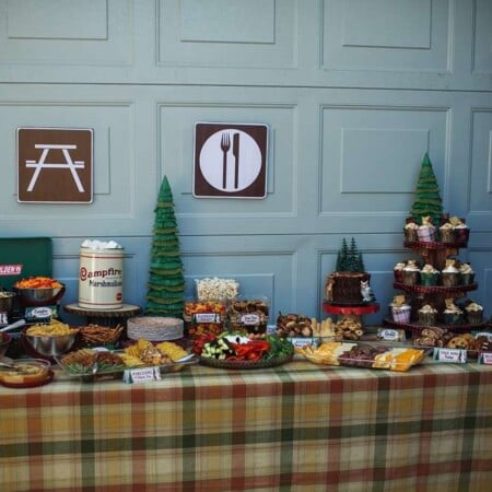 Plaid tablecloth with camping party food on top