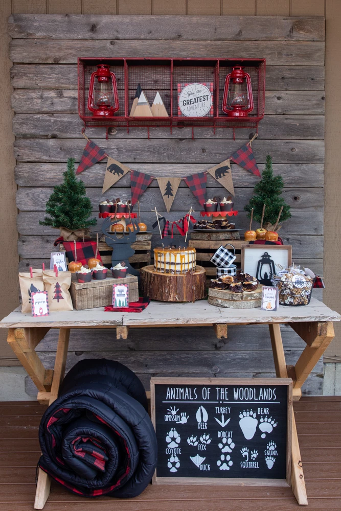 camp themed party table with buffalo plaid