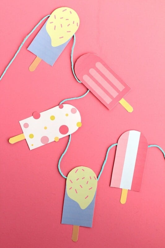 Popsicle garland on a pink background