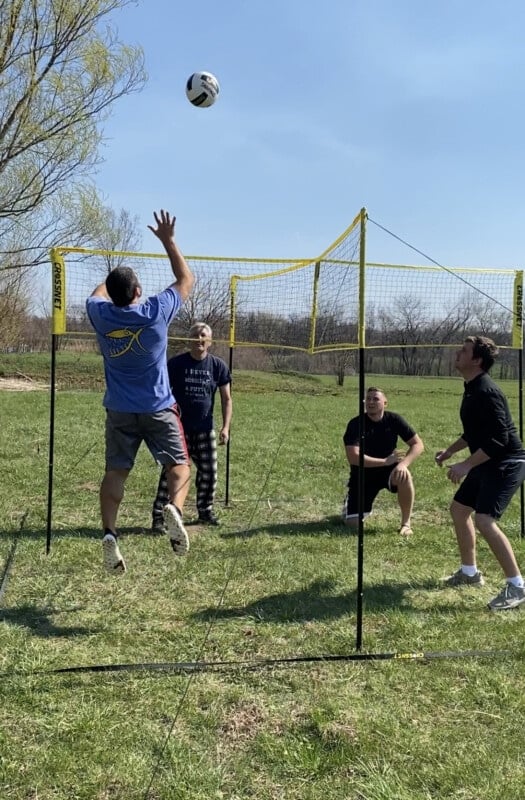 four people playing a game of crossnet