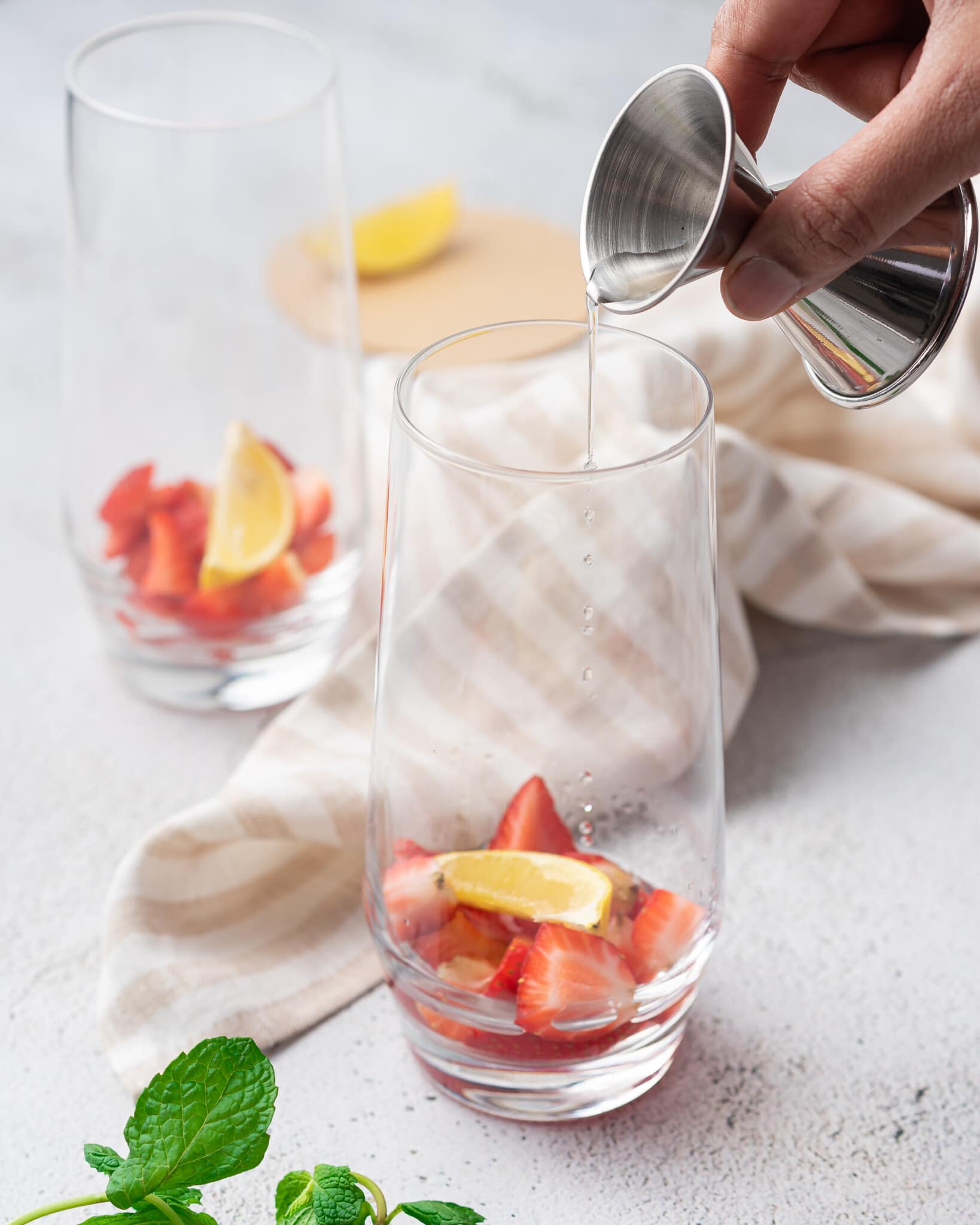 Fresh strawberries and lemons in the bottom of a glass