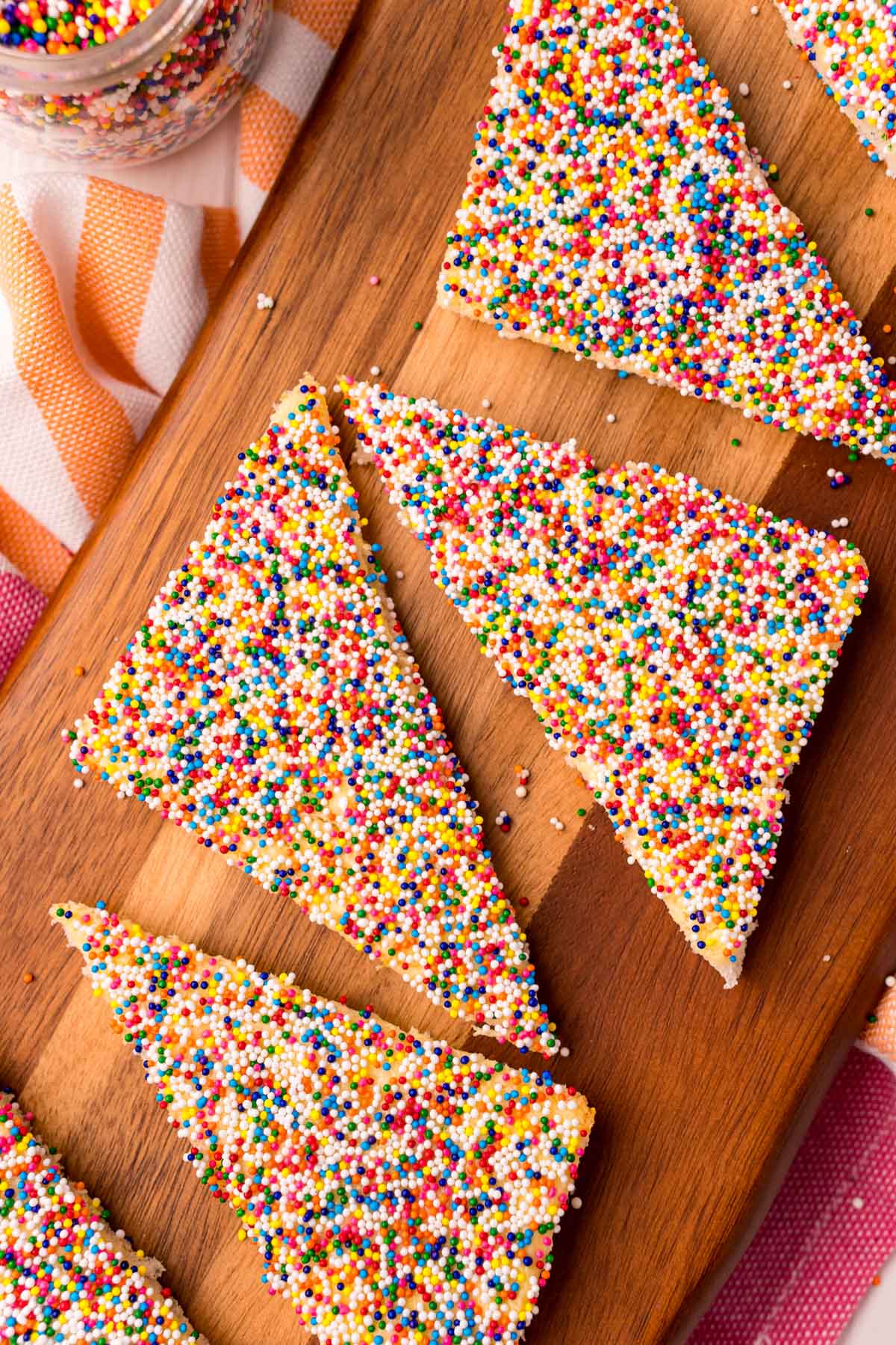 four pieces of fairy bread on a cutting board