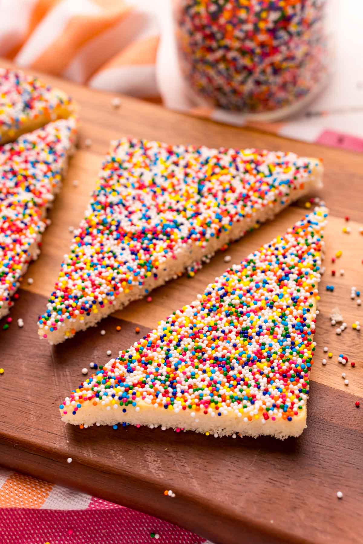 two pieces of fairy bread on a cutting board