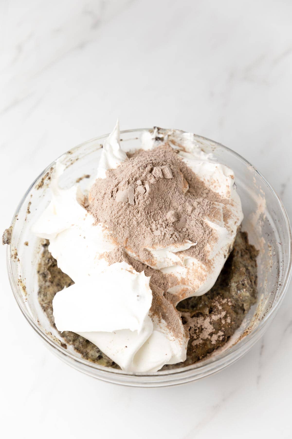 whipped topping and chocolate pudding mix in a bowl