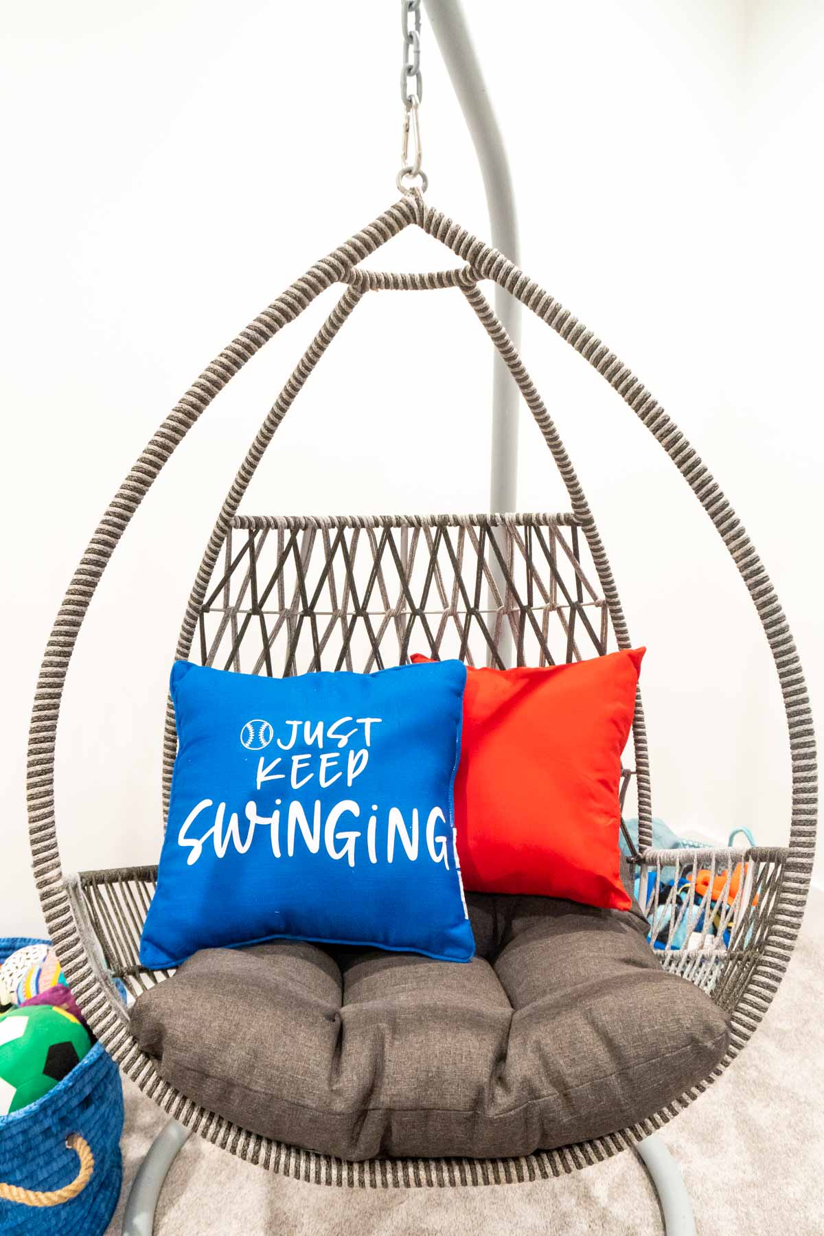 swing chair with two pillows in it