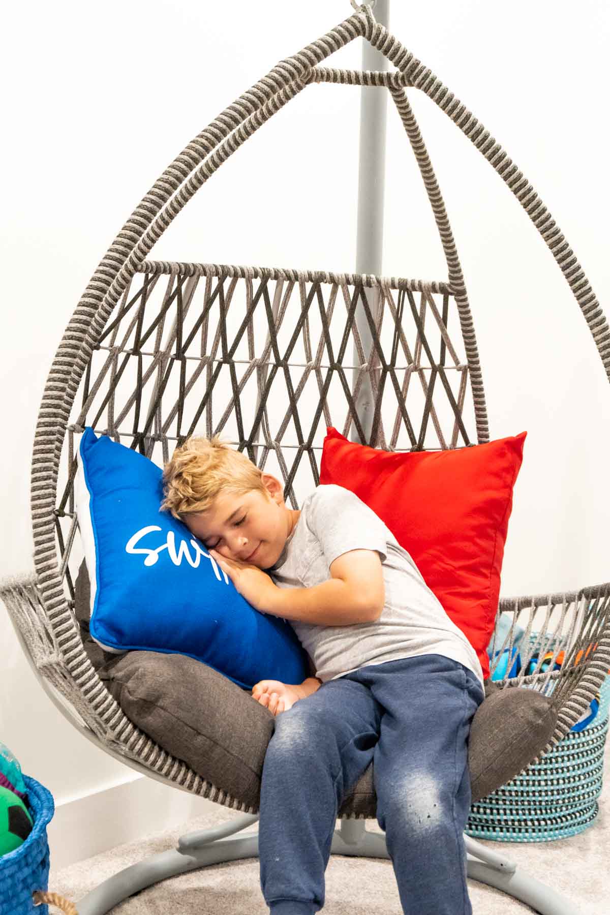 kid sleeping in a swing chair