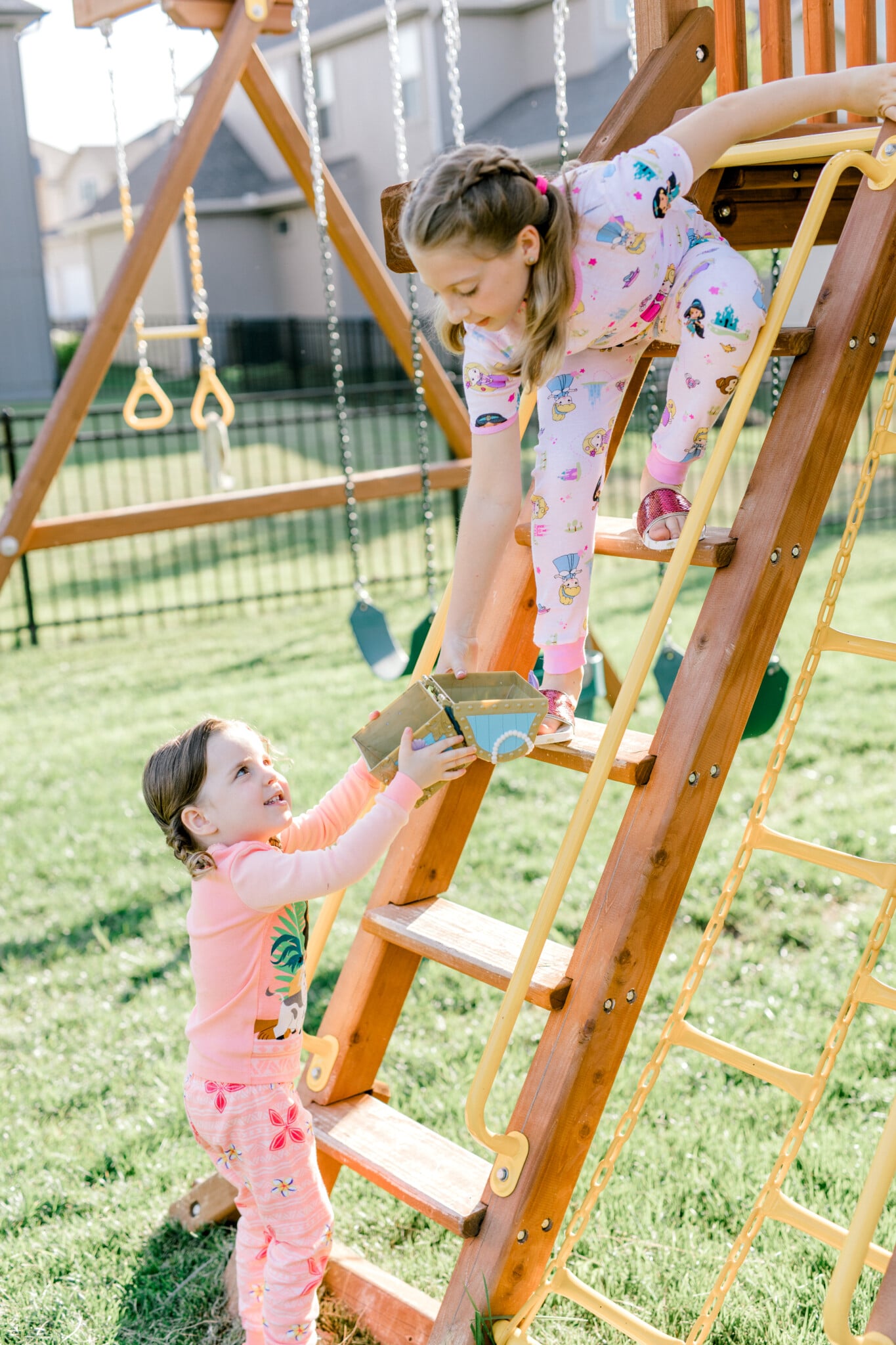 grls climbing a ladder with a treasure chest