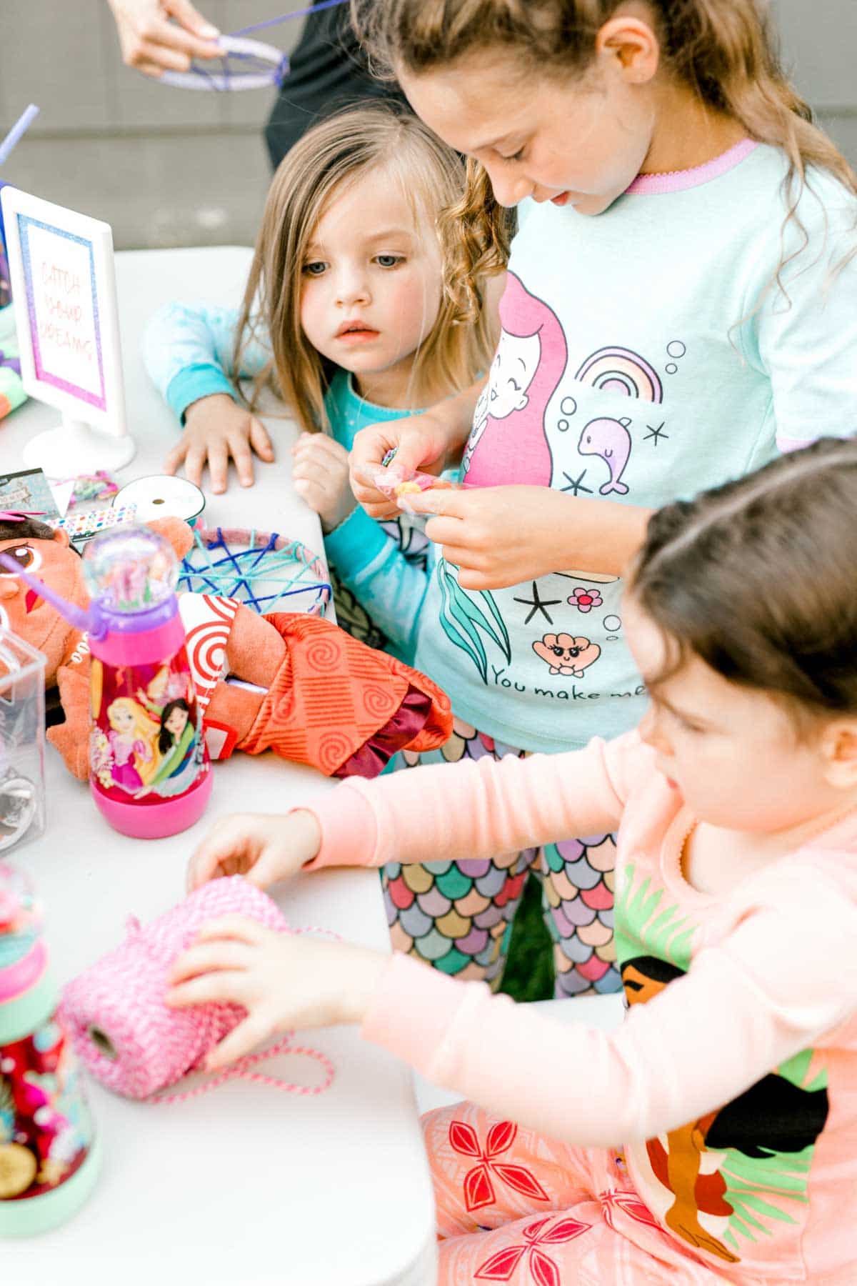 craft supplies and girls at a table