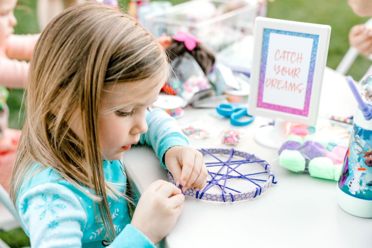 girl wrapping a dream catcher