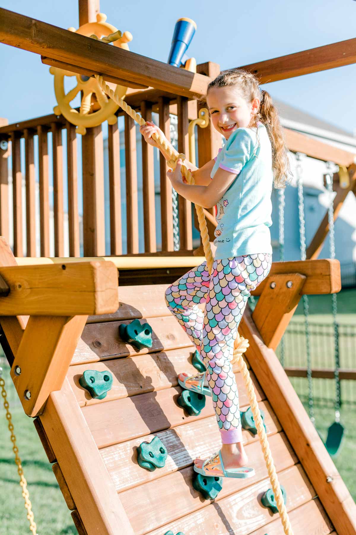 girl clmibing a rock wall