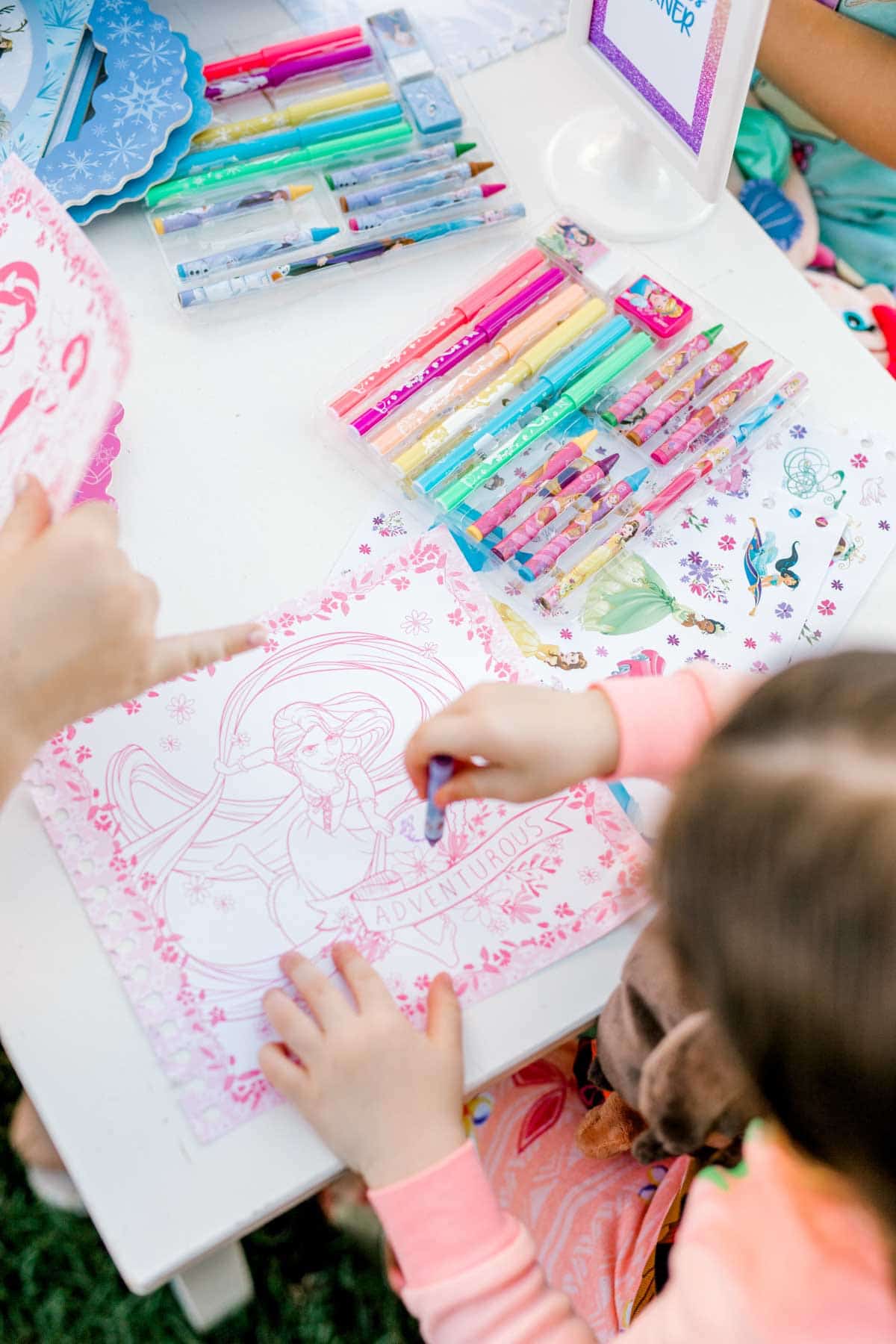 girl coloring on a princess activity kit