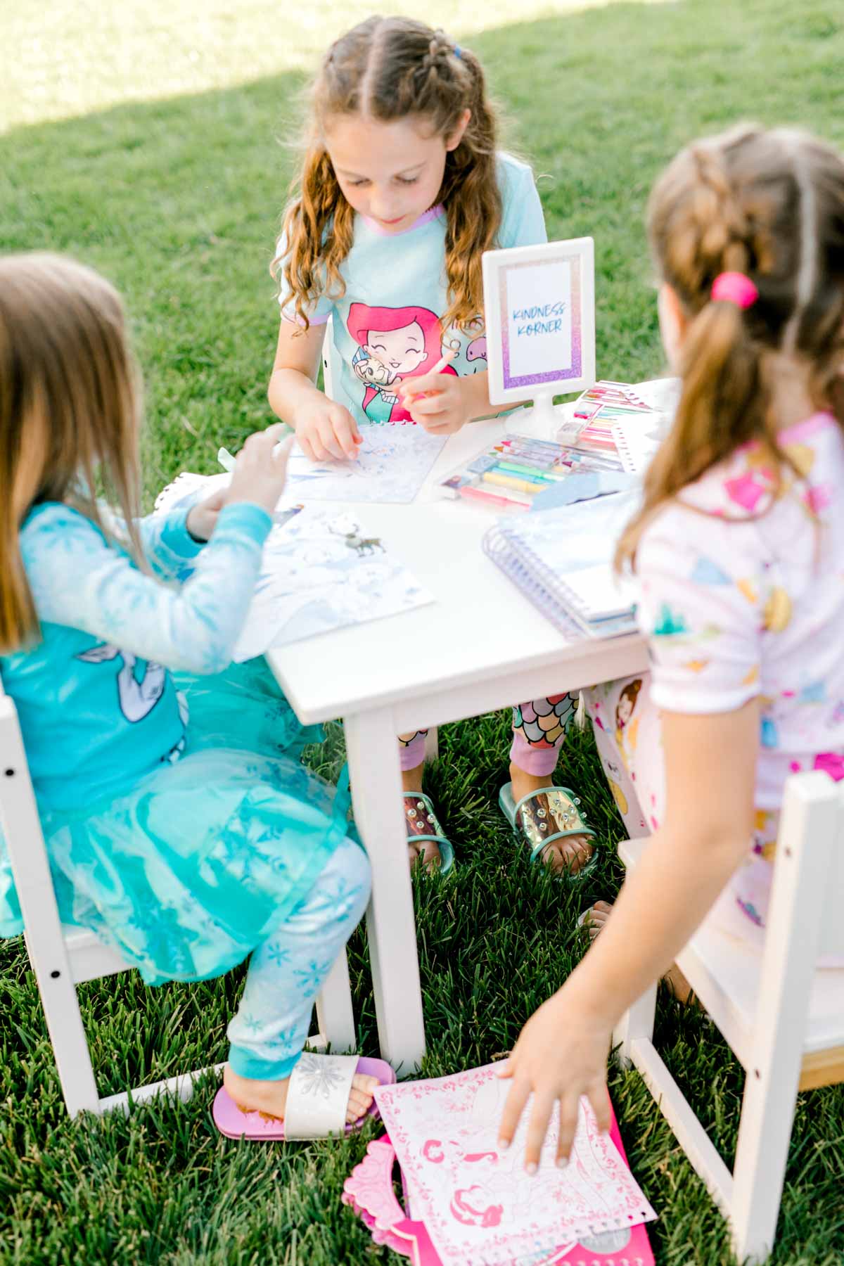 girls at a table coloring 