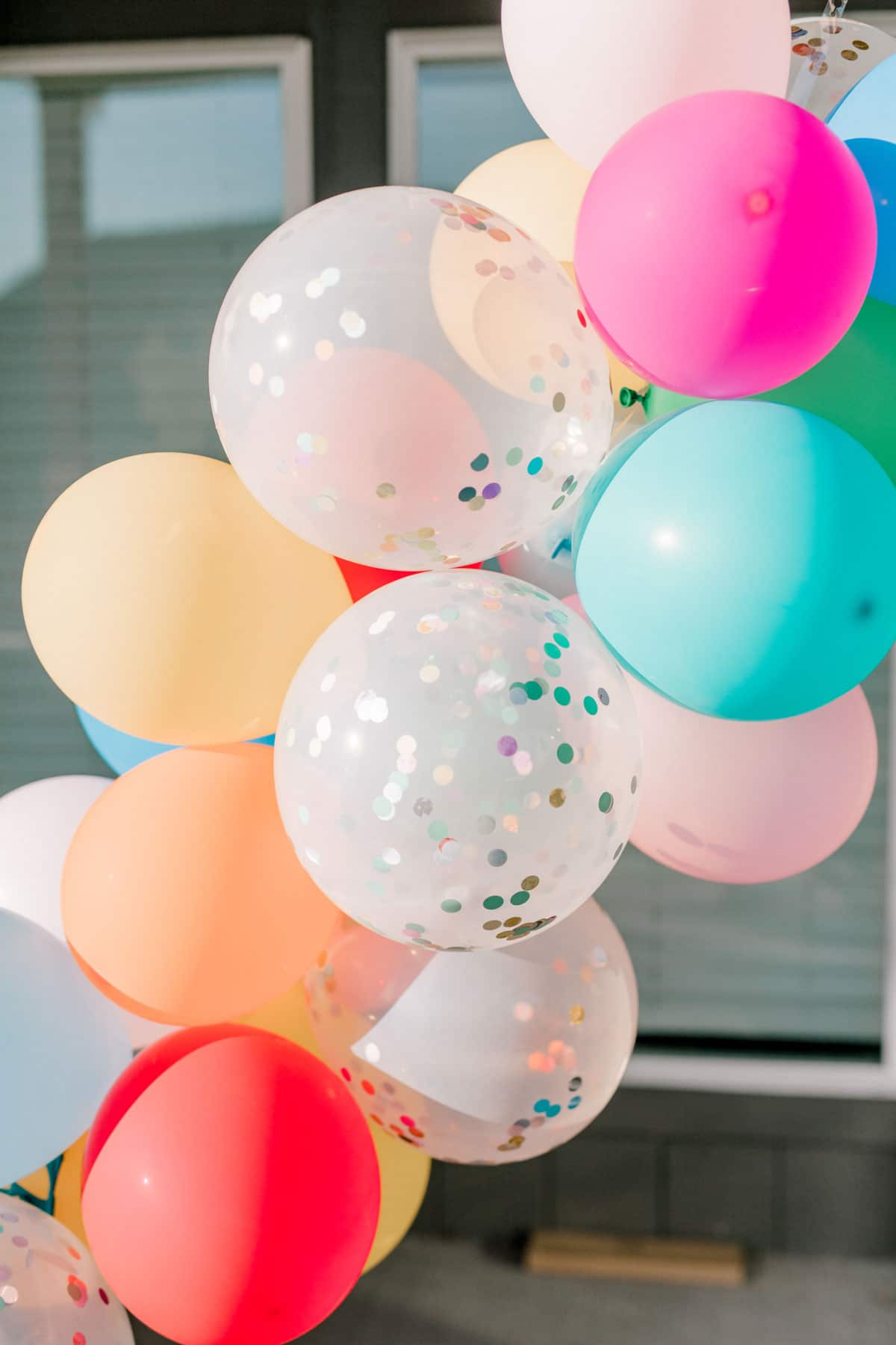 a balloon garland with confetti balloons