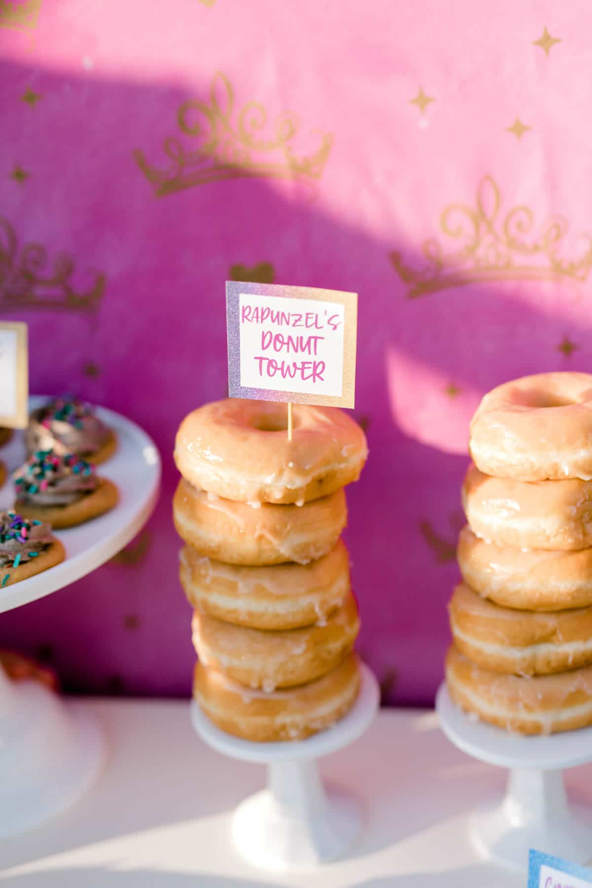 tower of donuts with a pink background