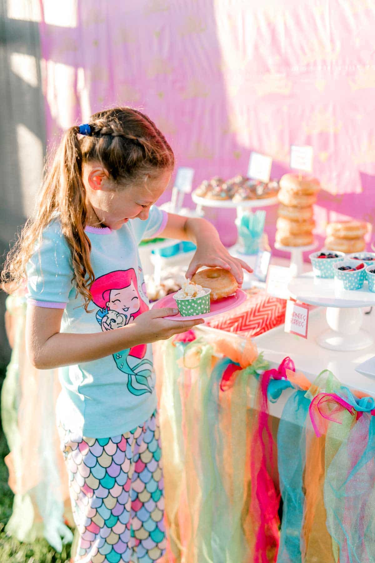 girl standing at a princess party table