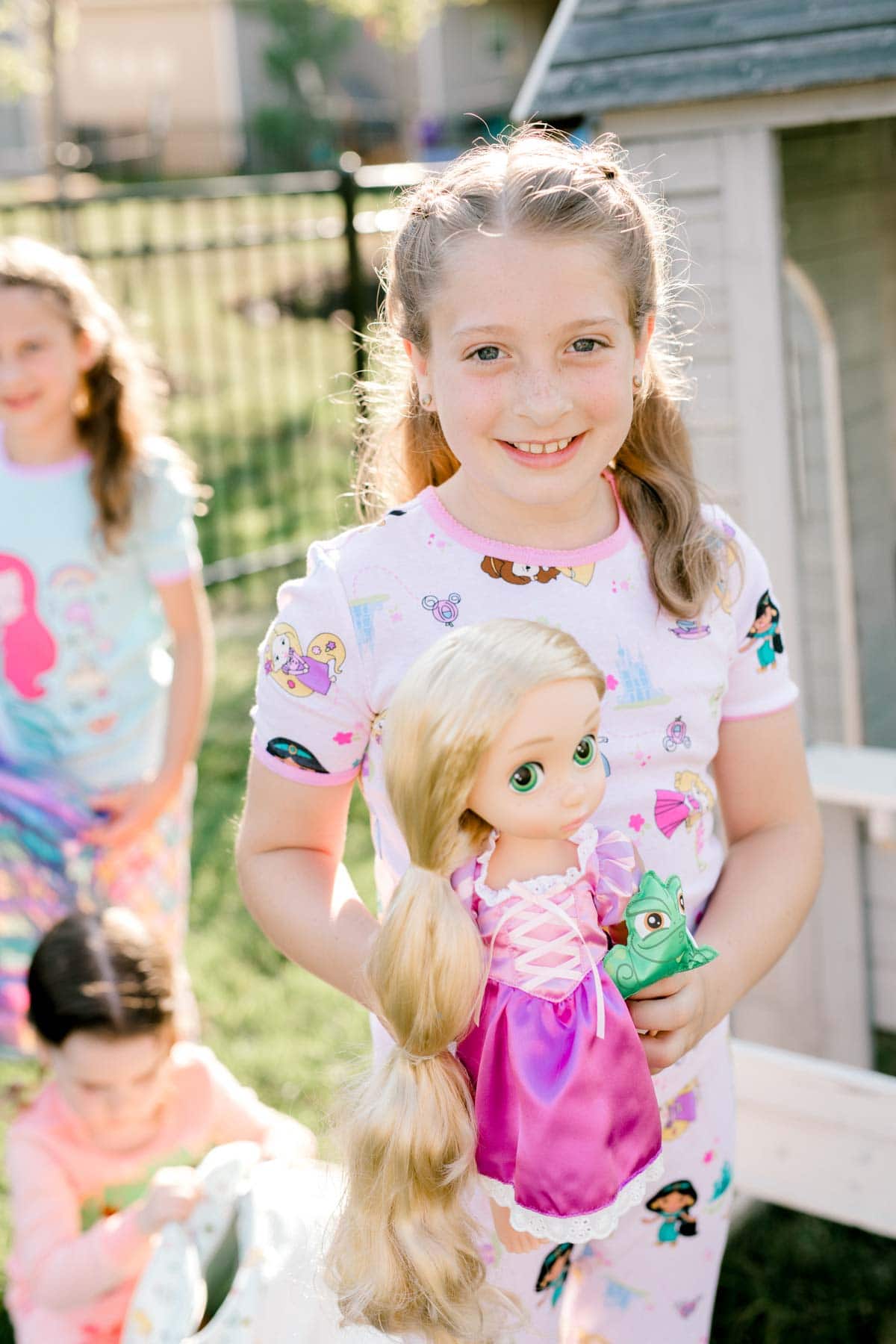 girl holding a Rapunzel doll