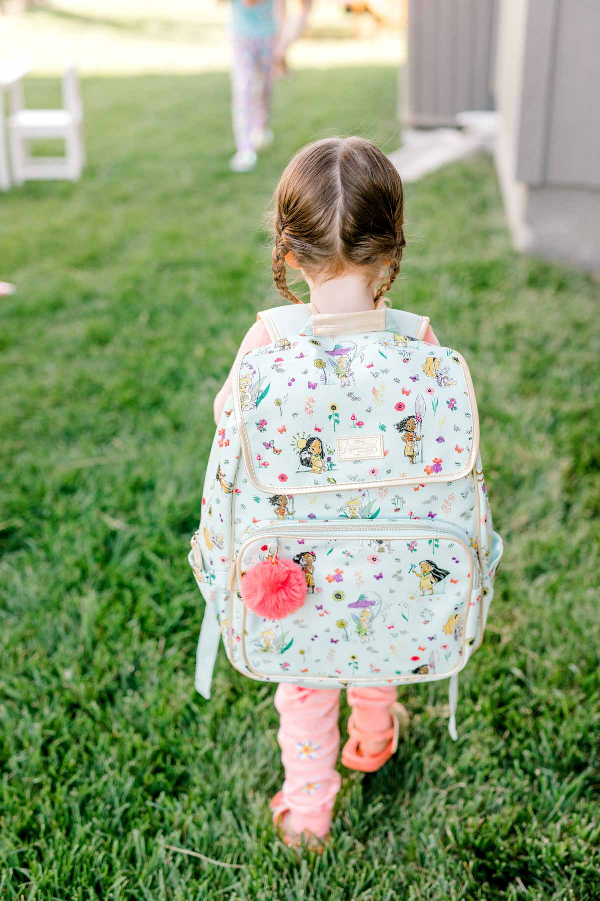 Girl wearing a Moana backpack