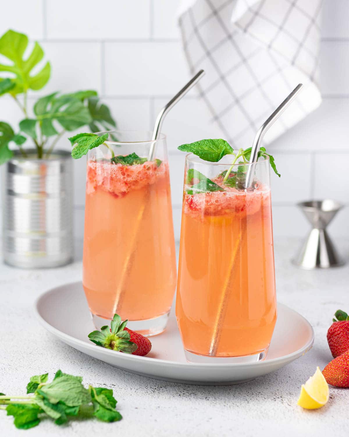 Two glasses of strawberry mojito mocktail with straws