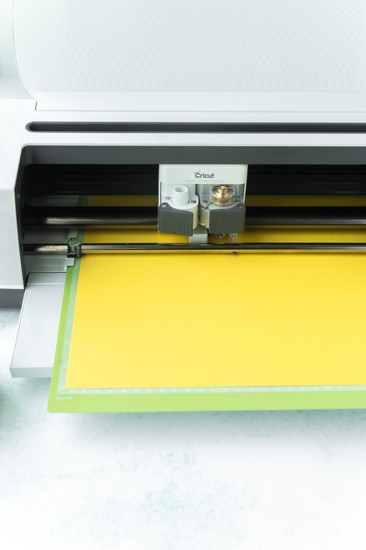 Cricut Maker loaded with yellow card stock