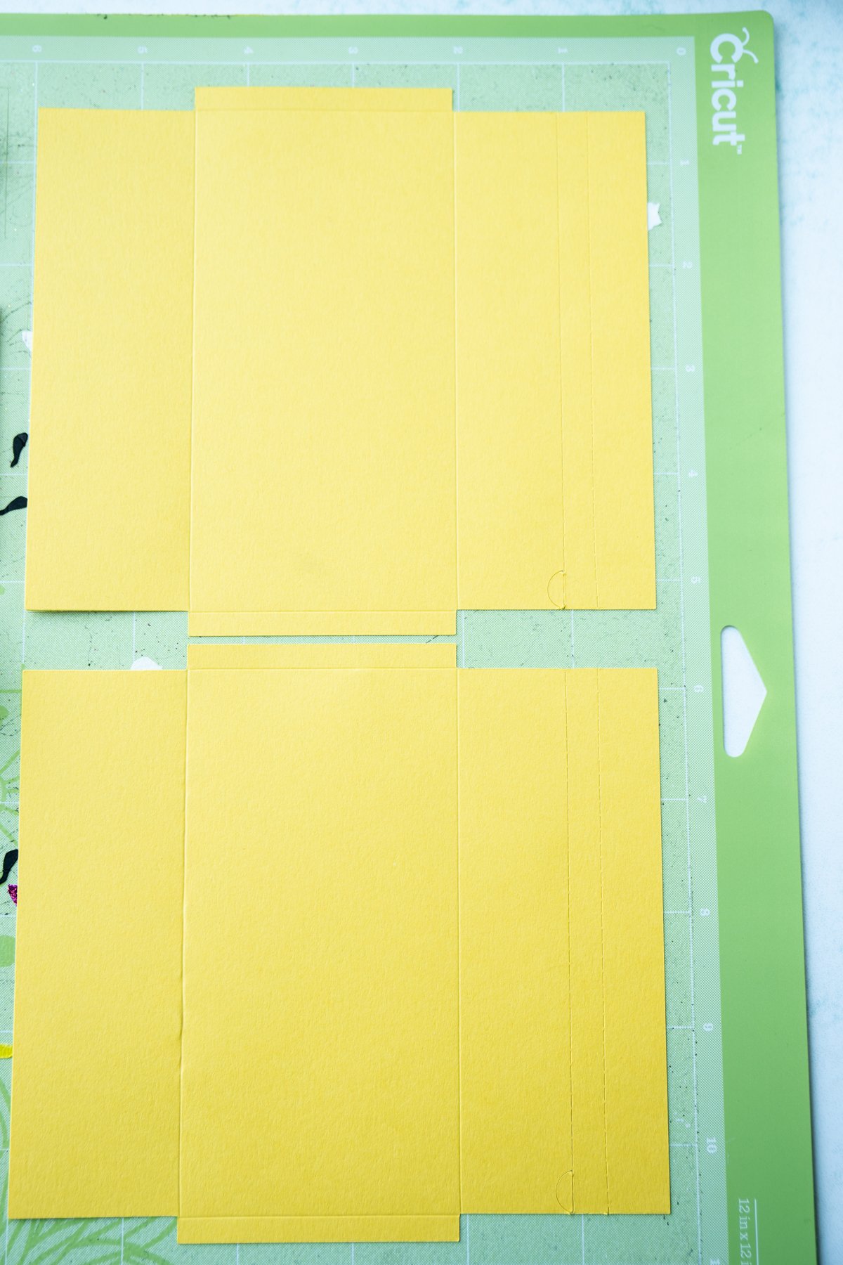 Flat yellow envelopes on a Cricut mat