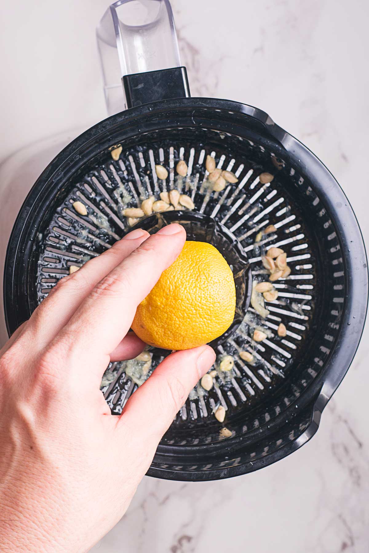 hand juicing a lemon on a juicer