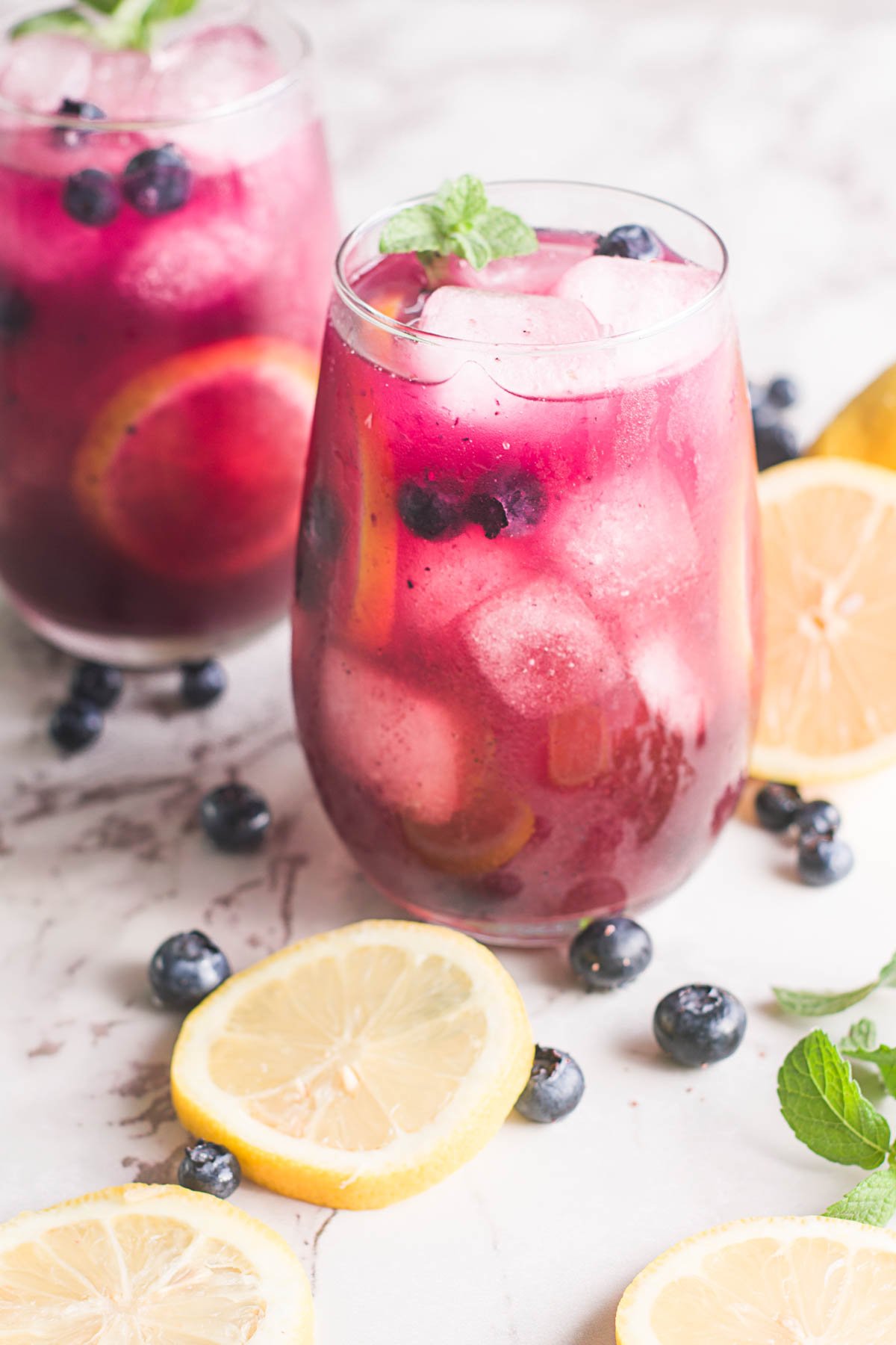 two glasses of blueberry lemonade