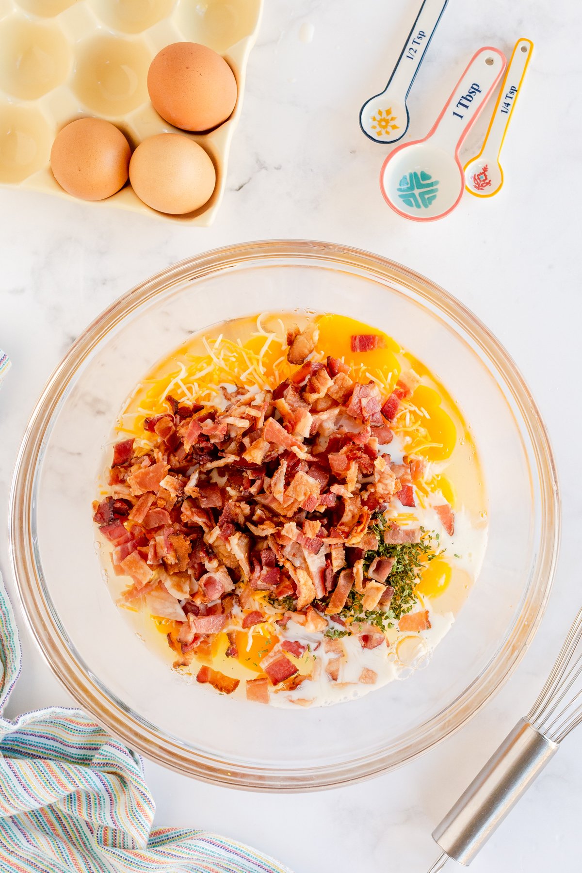 uncooked egg mixture for breakfast muffins in a bowl