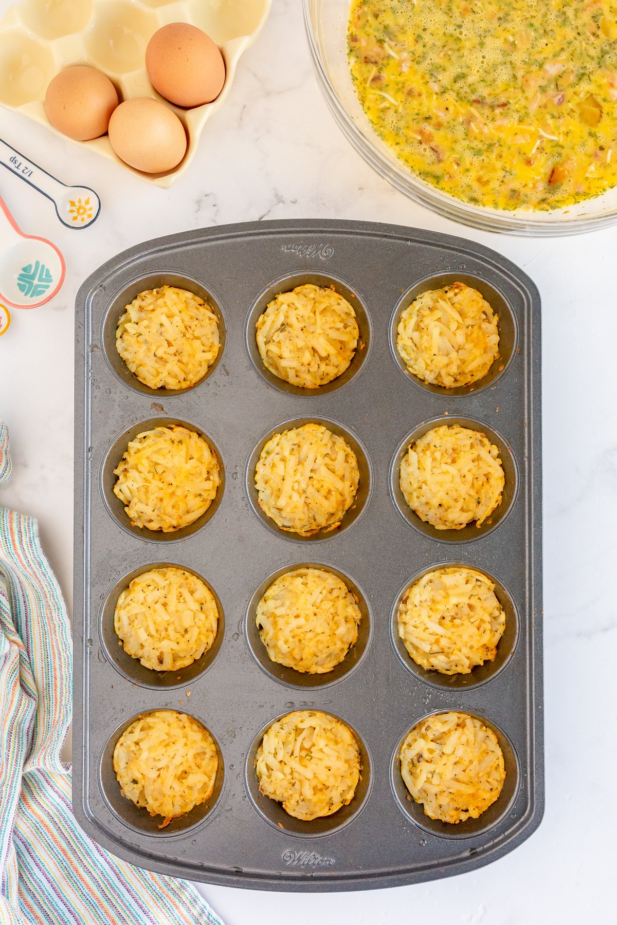 hash brown crusts in a muffin tin