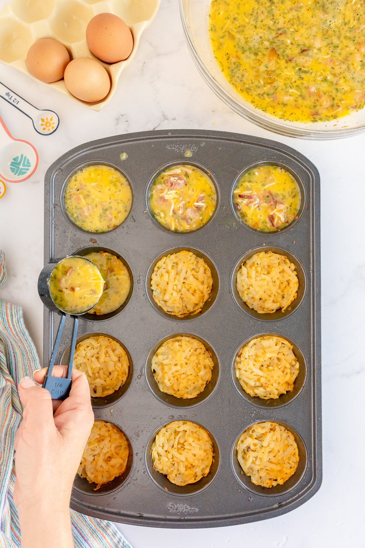 uncooked breakfast muffins in a muffin tin