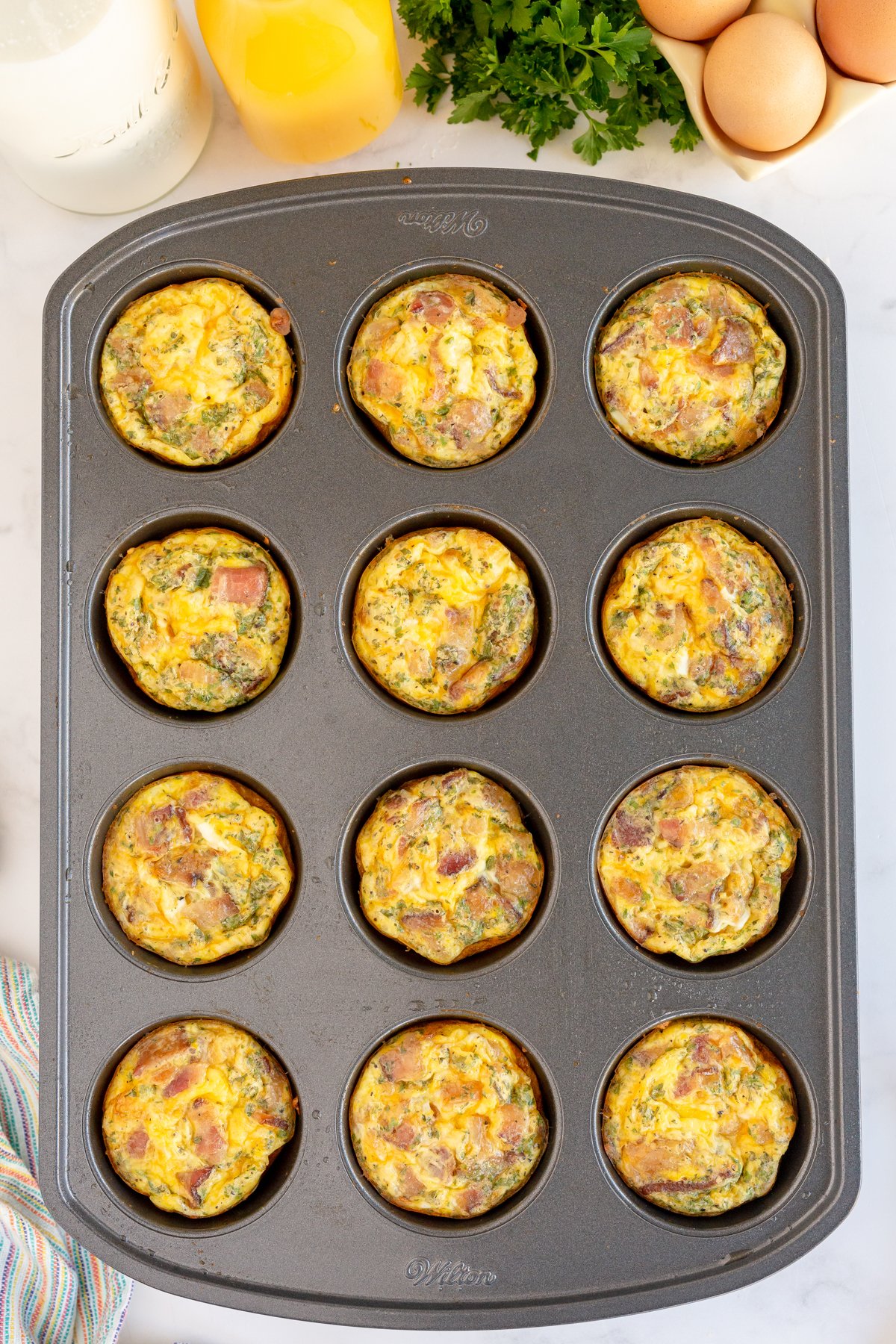 uncooked breakfast muffins in a muffin tin