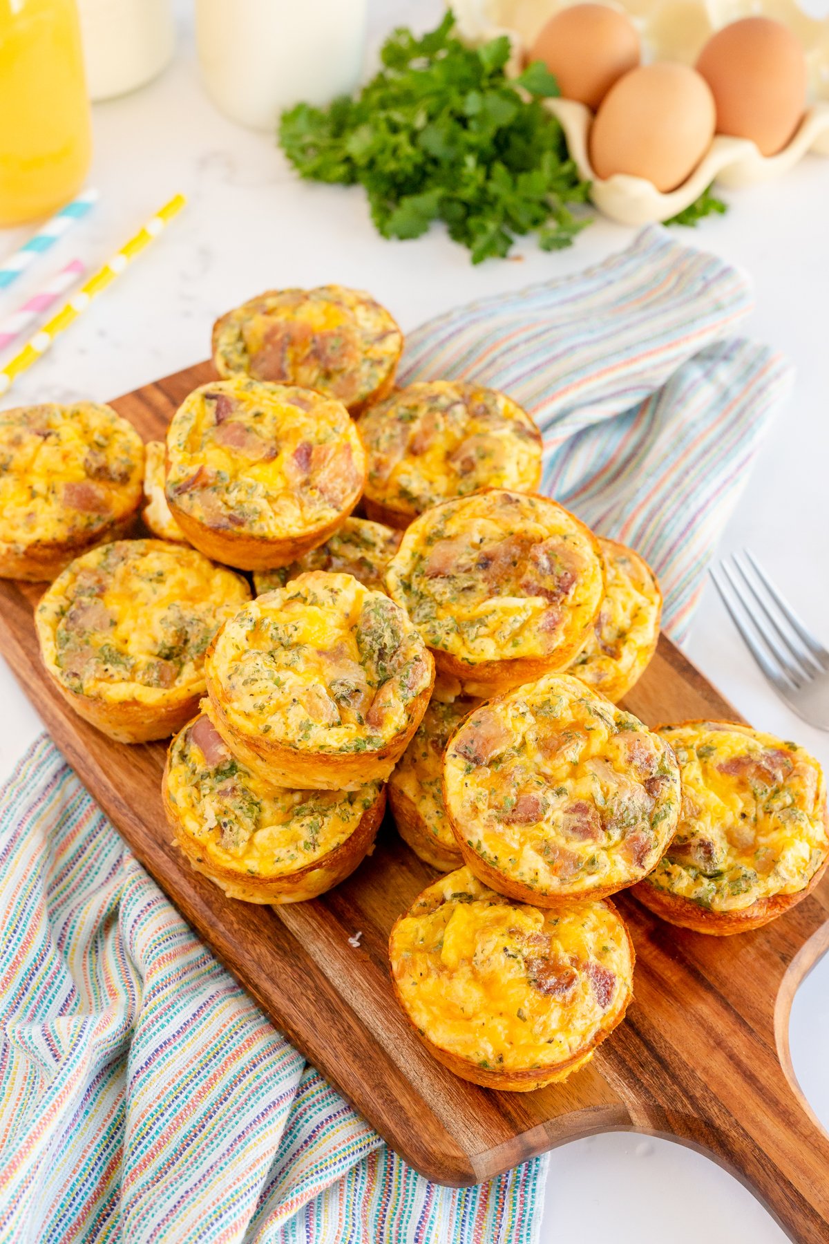 stack of breakfast muffins on a wood cutting board