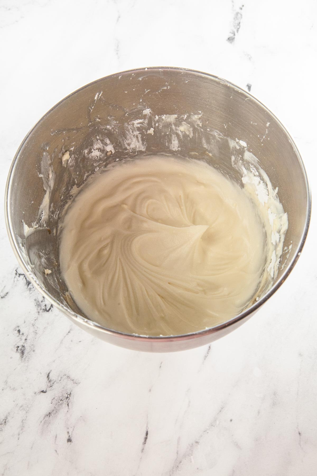 cream cheese frosting in a metal bowl