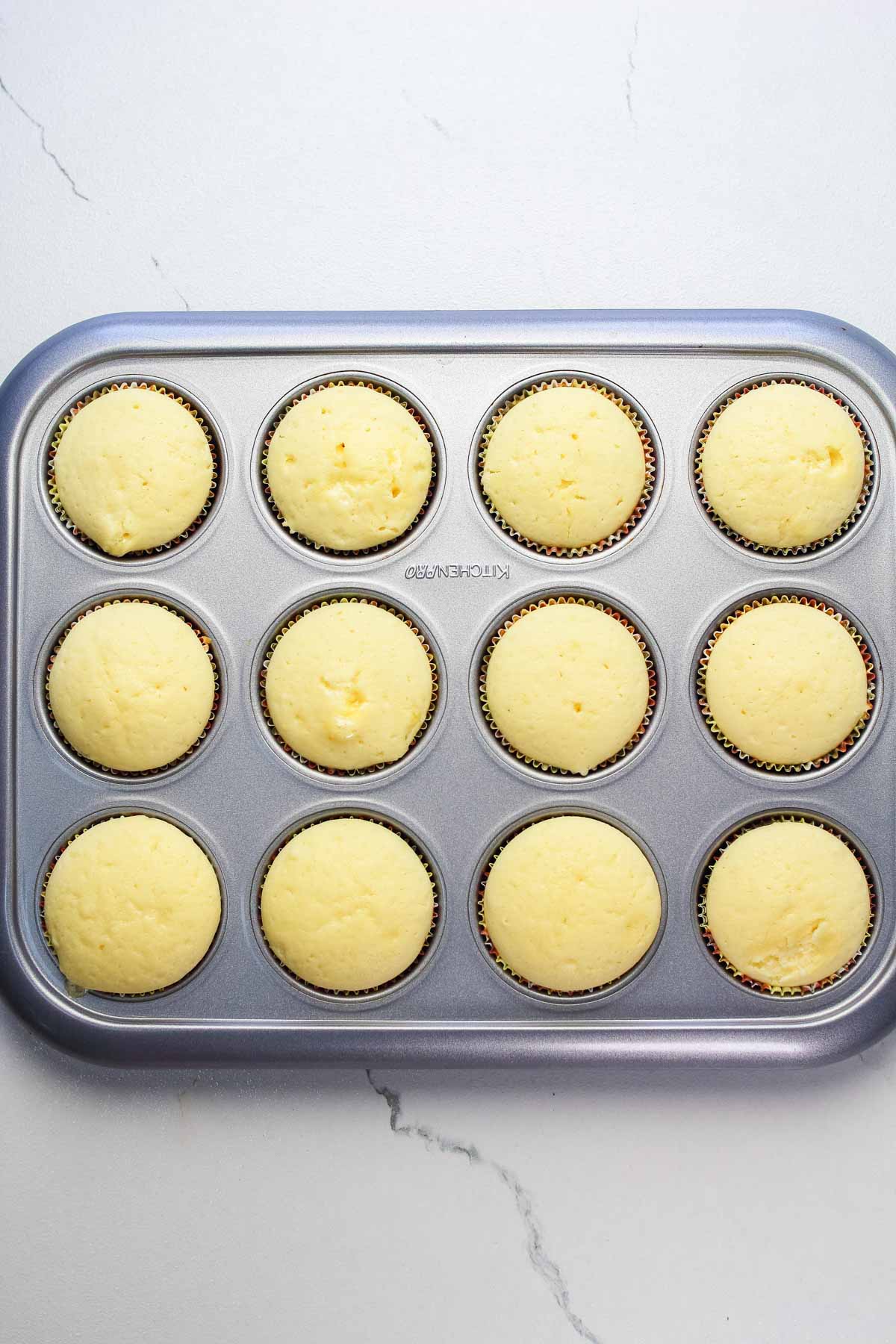 Baked lemon cupcakes still in the cupcake pan