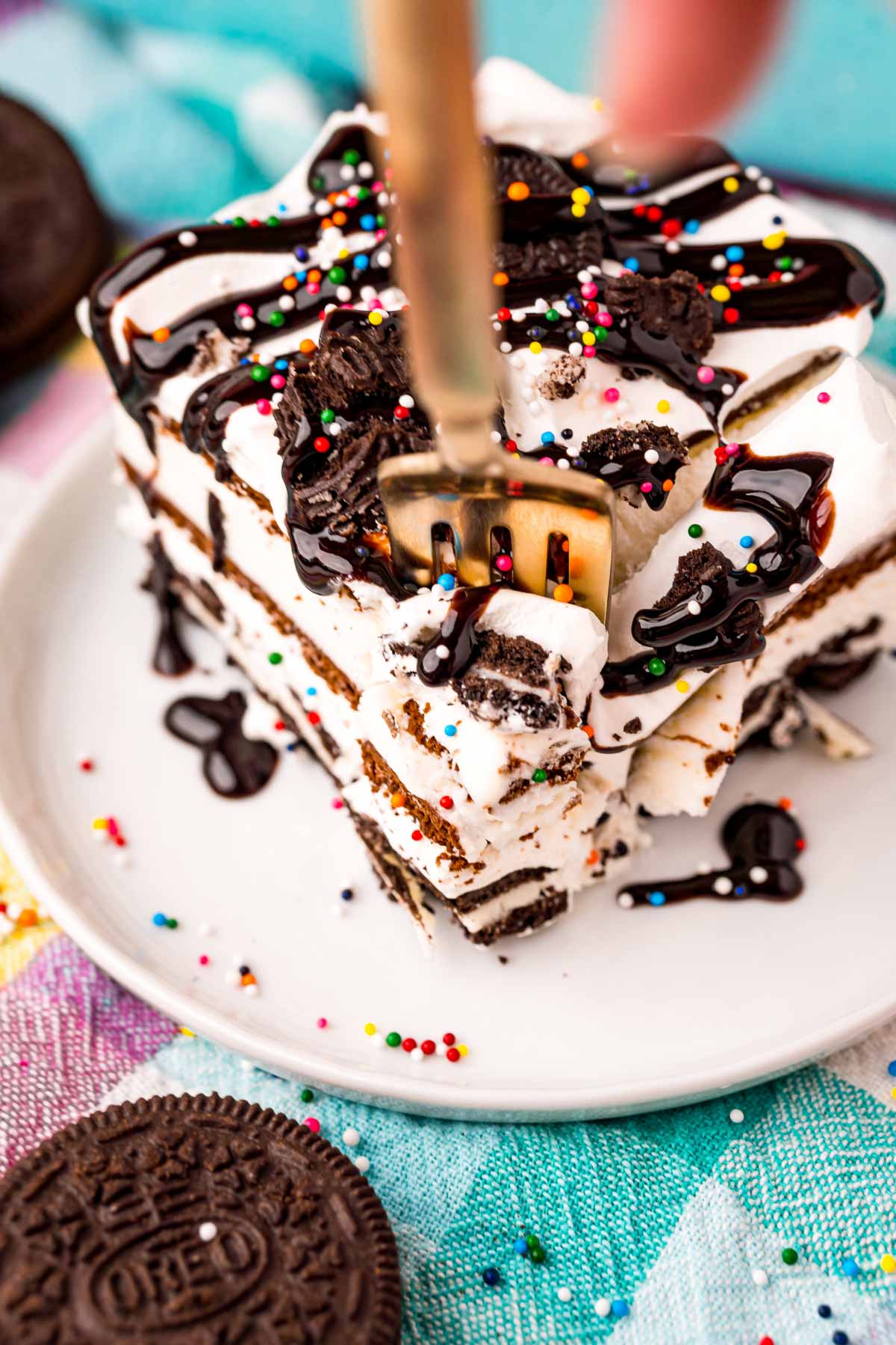 fork taking a bite out of a slice of ice cream cake