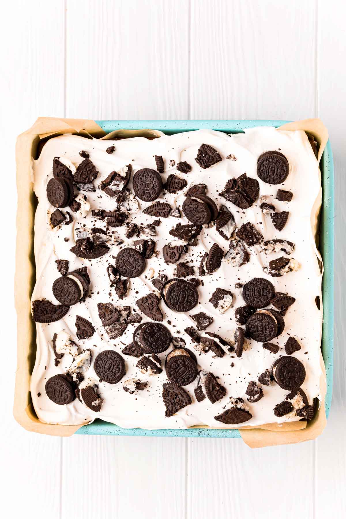 Oreo ice cream cake in a square pan ready to be frozen