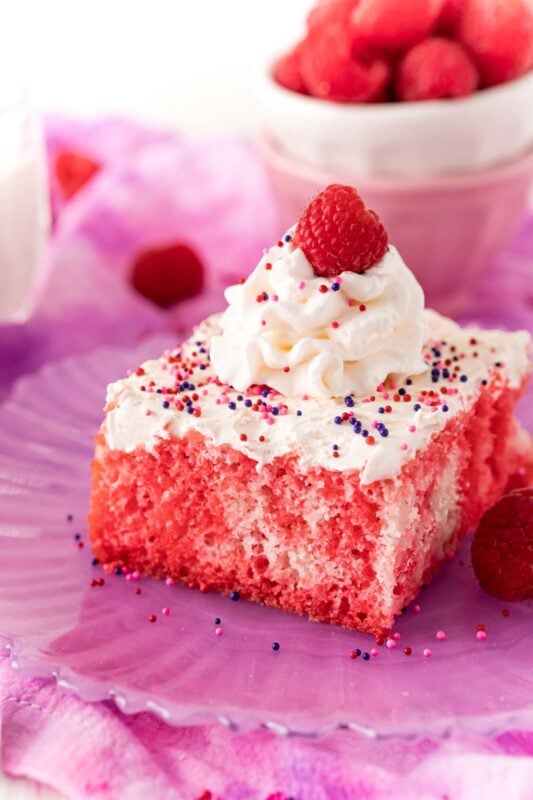 slice of raspberry jello poke cake on a purple plate