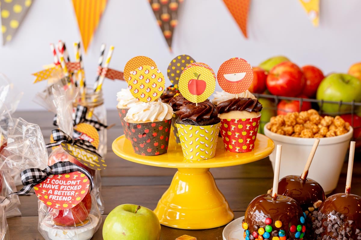 cake stand with cupcakes wrapped in apple cupcake wrappers