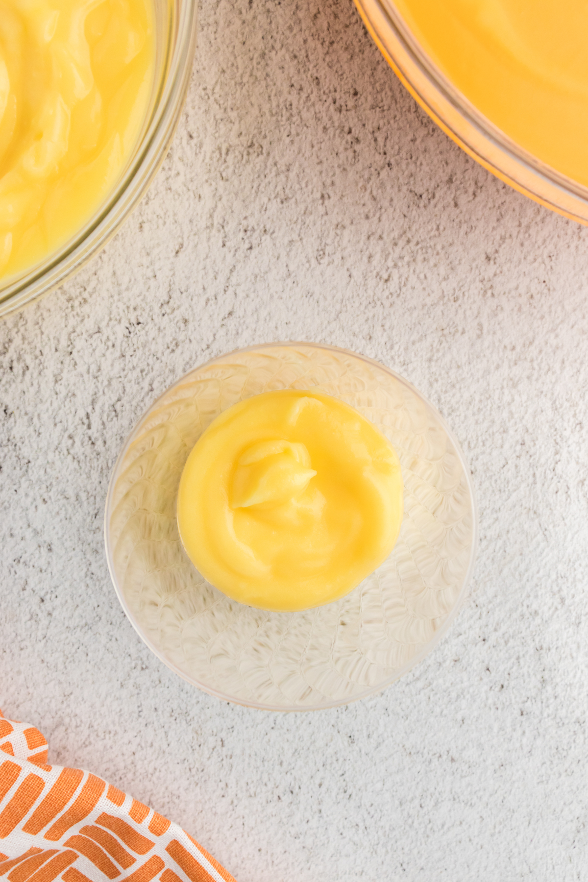 plastic cup with yellow pudding inside