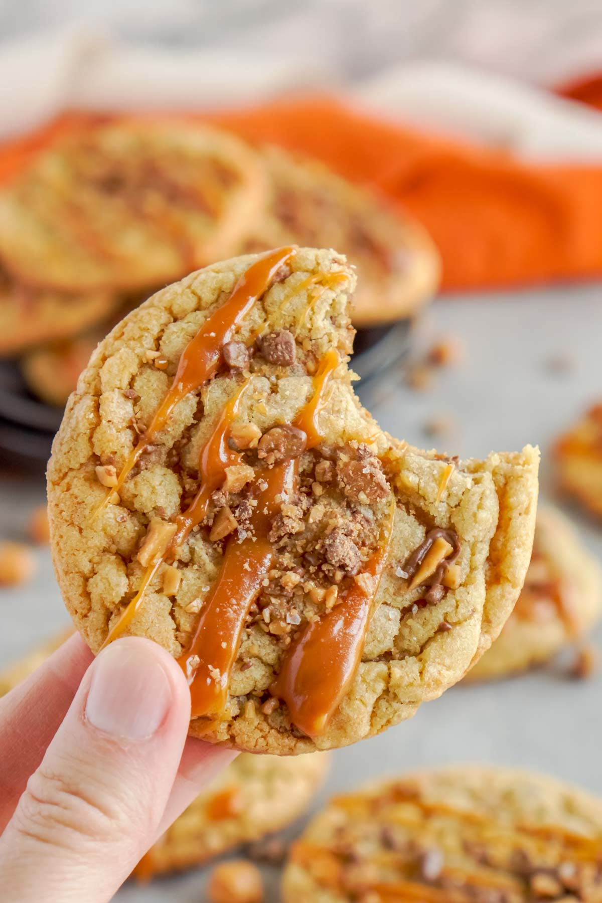 hand holding a caramel toffee cookie