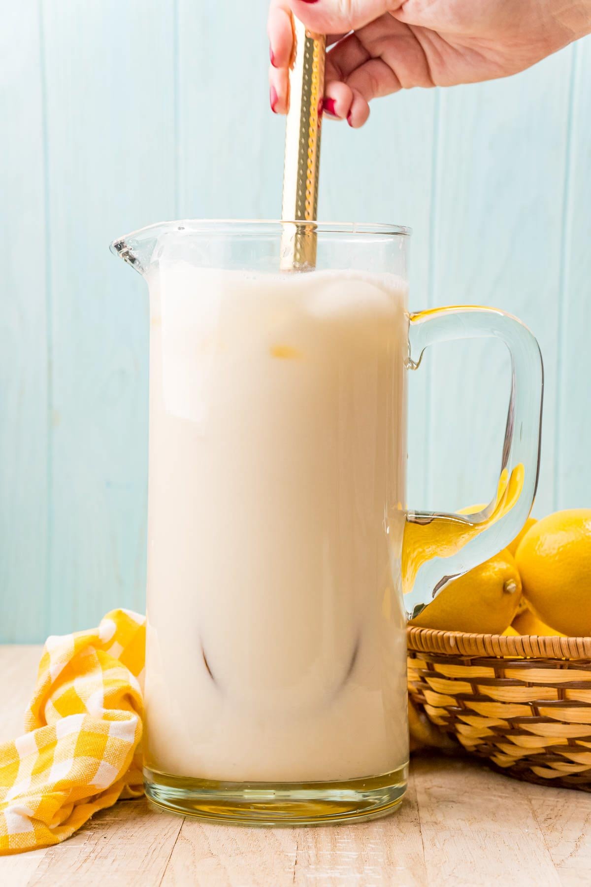 pitcher of creamy lemonade being stirred